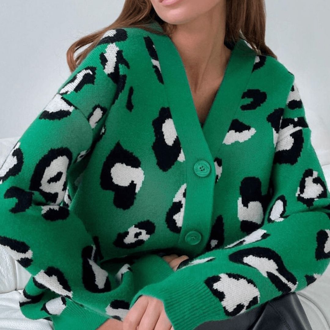 Grüner Cardigan mit schwarz-weißem Leopardenmuster, V-Ausschnitt und Knöpfen. Modischer Damenpullover, ideal für Herbstmode und Streetstyle.