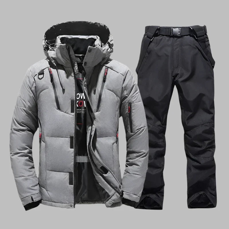Graue Winterjacke und schwarze Skihose für Herren, wasserdicht und winddicht, ideal für Outdoor-Aktivitäten und Wintersport.