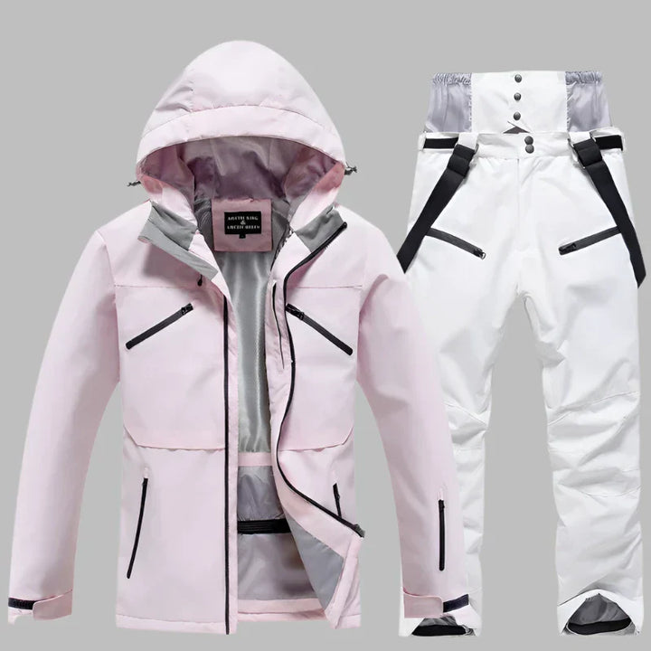 Damen Skijacke und Skihose Set in Rosa und Weiß, wasserdicht, winddicht, mit Kapuze und Reißverschlusstaschen, ideal für Wintersport.